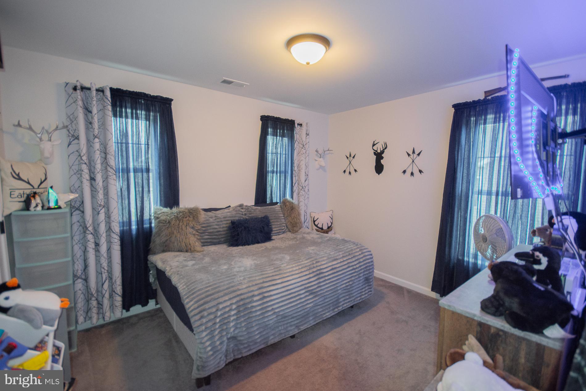 90 Larimar Lane Inwood, WV 25428 - Photo 30 of 66 a bedroom with a bed and a mirror