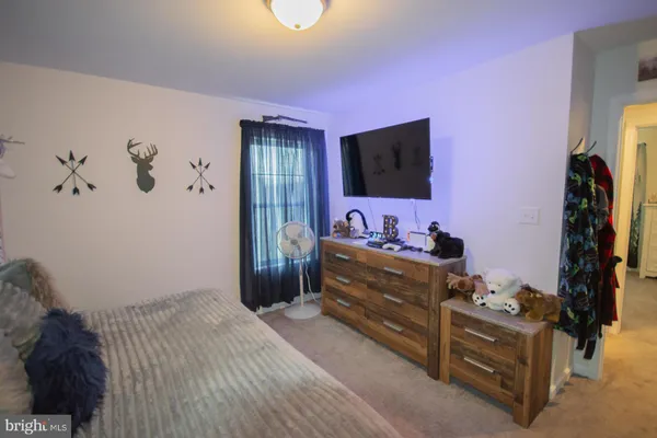 a bedroom with furniture and a baby crib