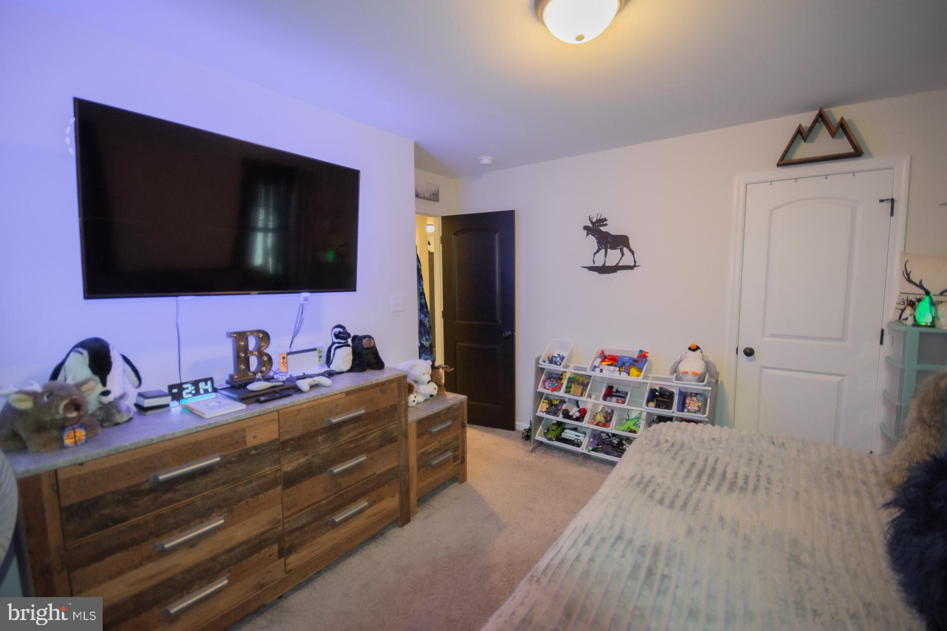 90 Larimar Lane Inwood, WV 25428 - Photo 32 of 66 a bedroom with a bed and a flat screen tv