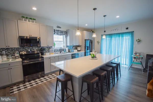 a large kitchen with a table and chairs