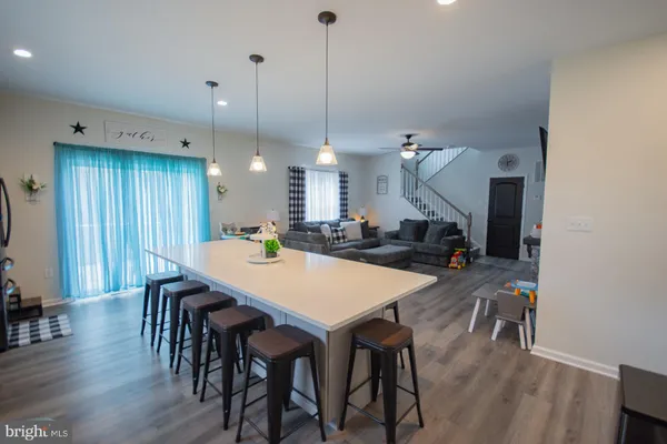 a large kitchen with a table and chairs