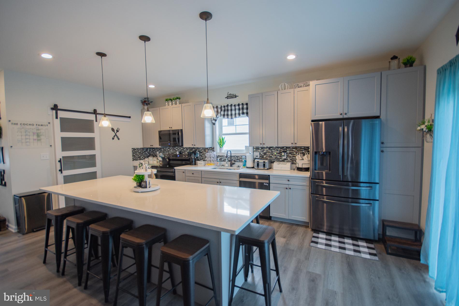 90 Larimar Lane Inwood, WV 25428 - Photo 10 of 66 a kitchen with kitchen island a refrigerator a stove a dining table and chairs
