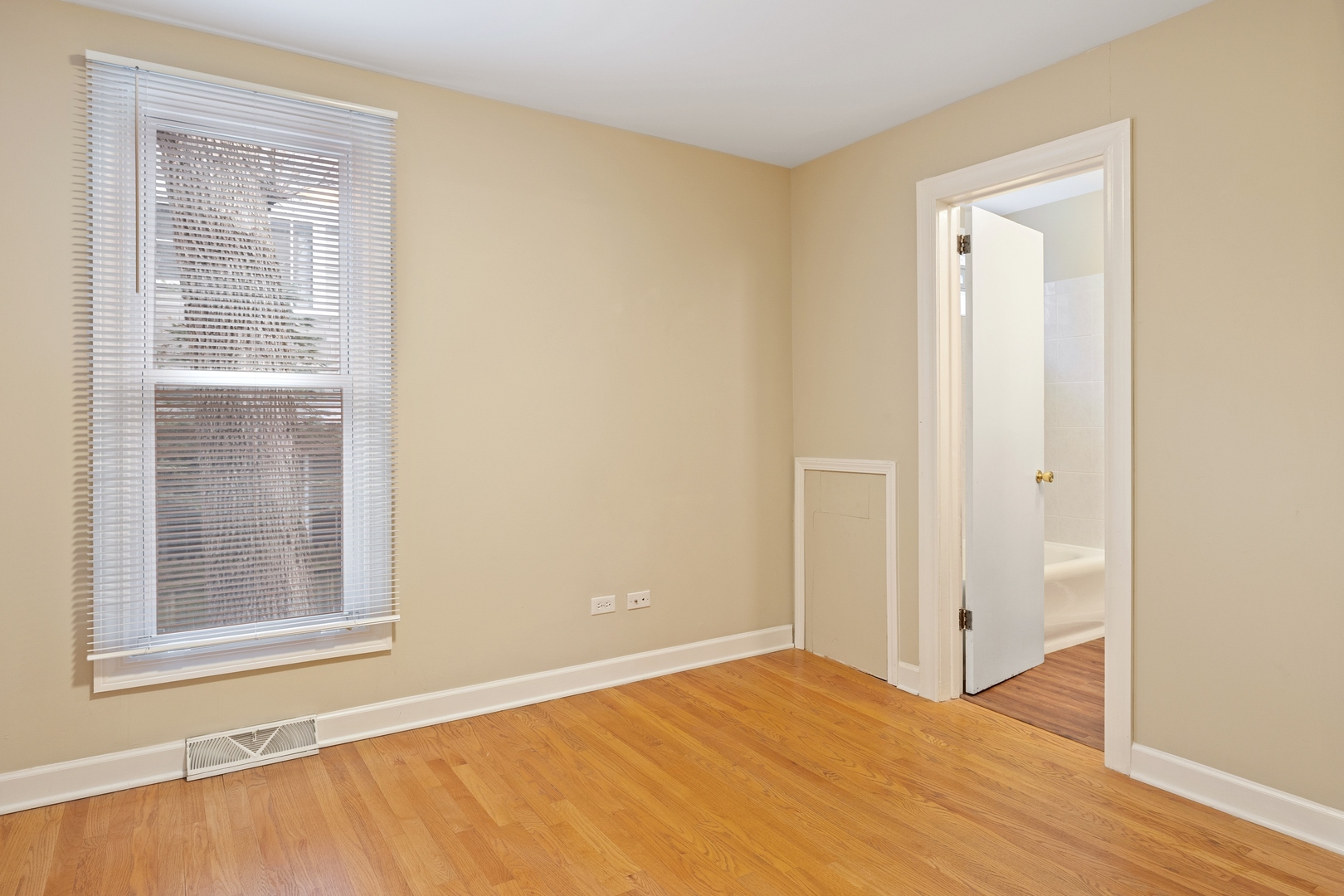 879 Willow Road Winnetka, IL 60093 - Photo 11 of 29 a view of an empty room with wooden floor and a window