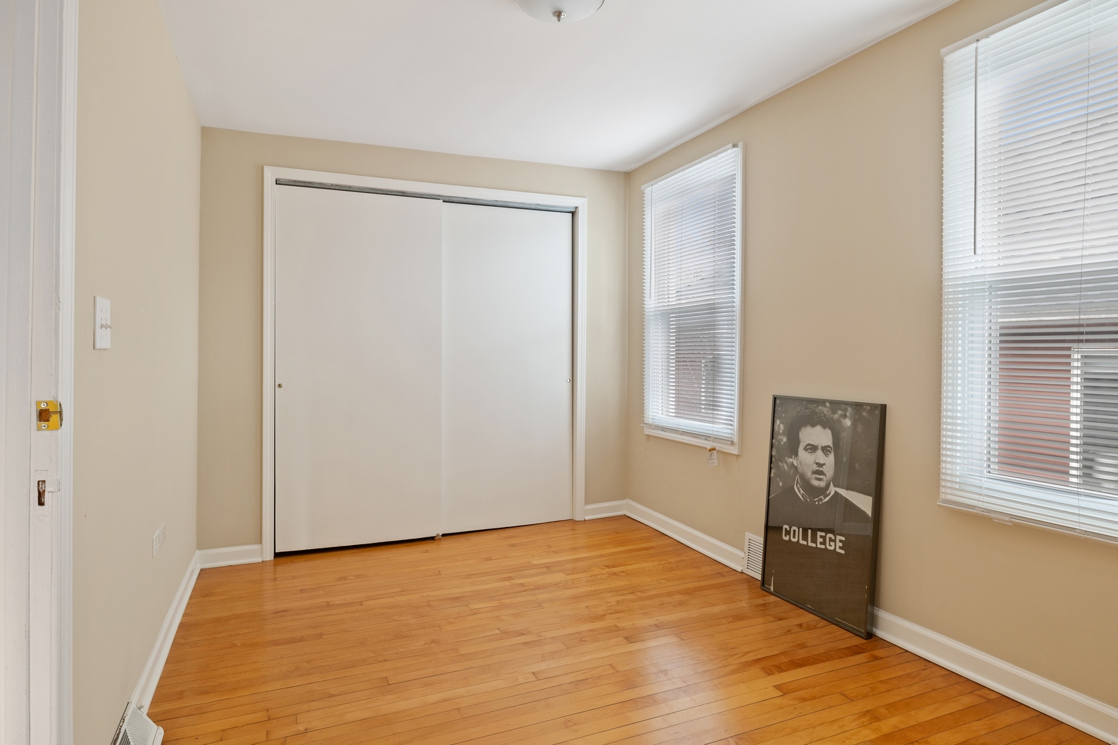 879 Willow Road Winnetka, IL 60093 - Photo 17 of 29 a view of an empty room with window and wooden floor