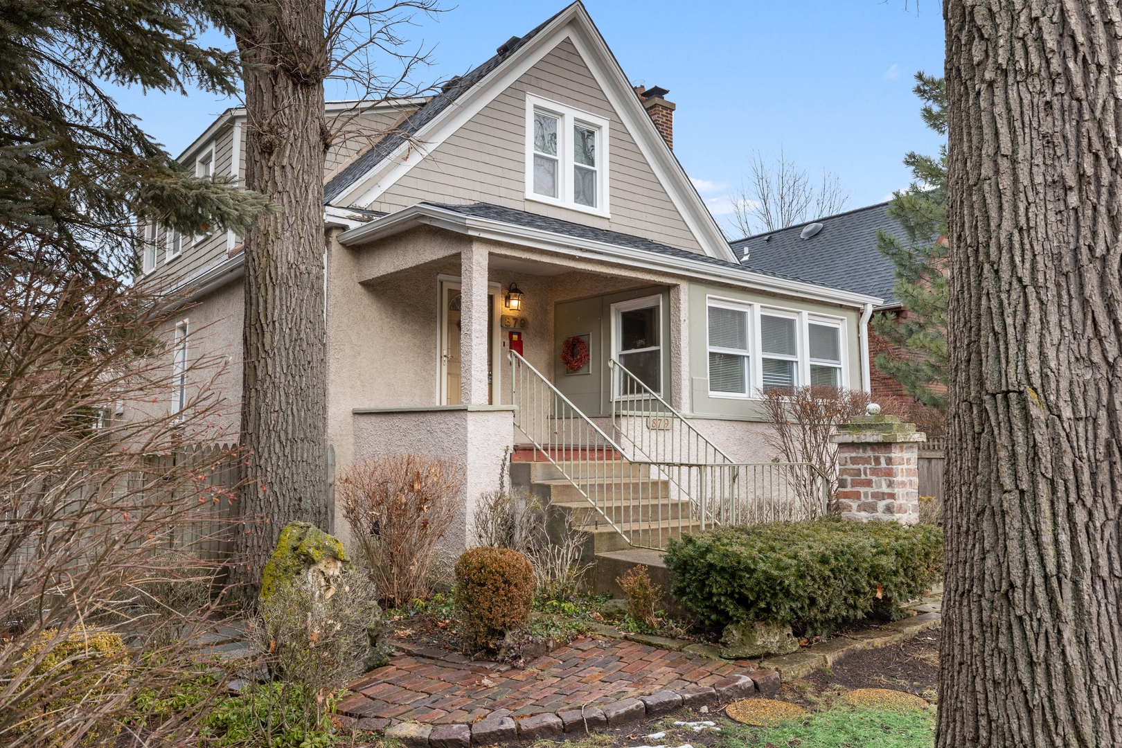 879 Willow Road Winnetka, IL 60093 - Photo 20 of 29 a front view of a house with garden