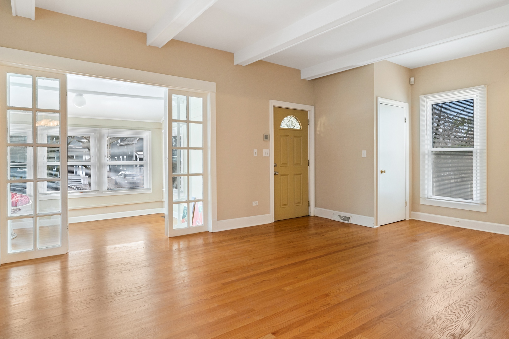879 Willow Road Winnetka, IL 60093 - Photo 3 of 29 a view of an empty room with wooden floor and a window