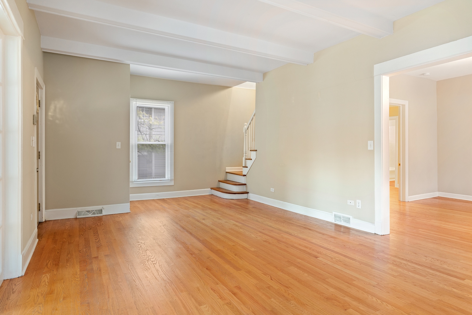 879 Willow Road Winnetka, IL 60093 - Photo 4 of 29 an empty room with wooden floor and windows