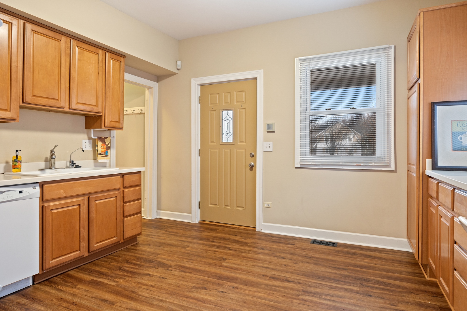 879 Willow Road Winnetka, IL 60093 - Photo 10 of 29 a large white kitchen with wooden floor and cabinets