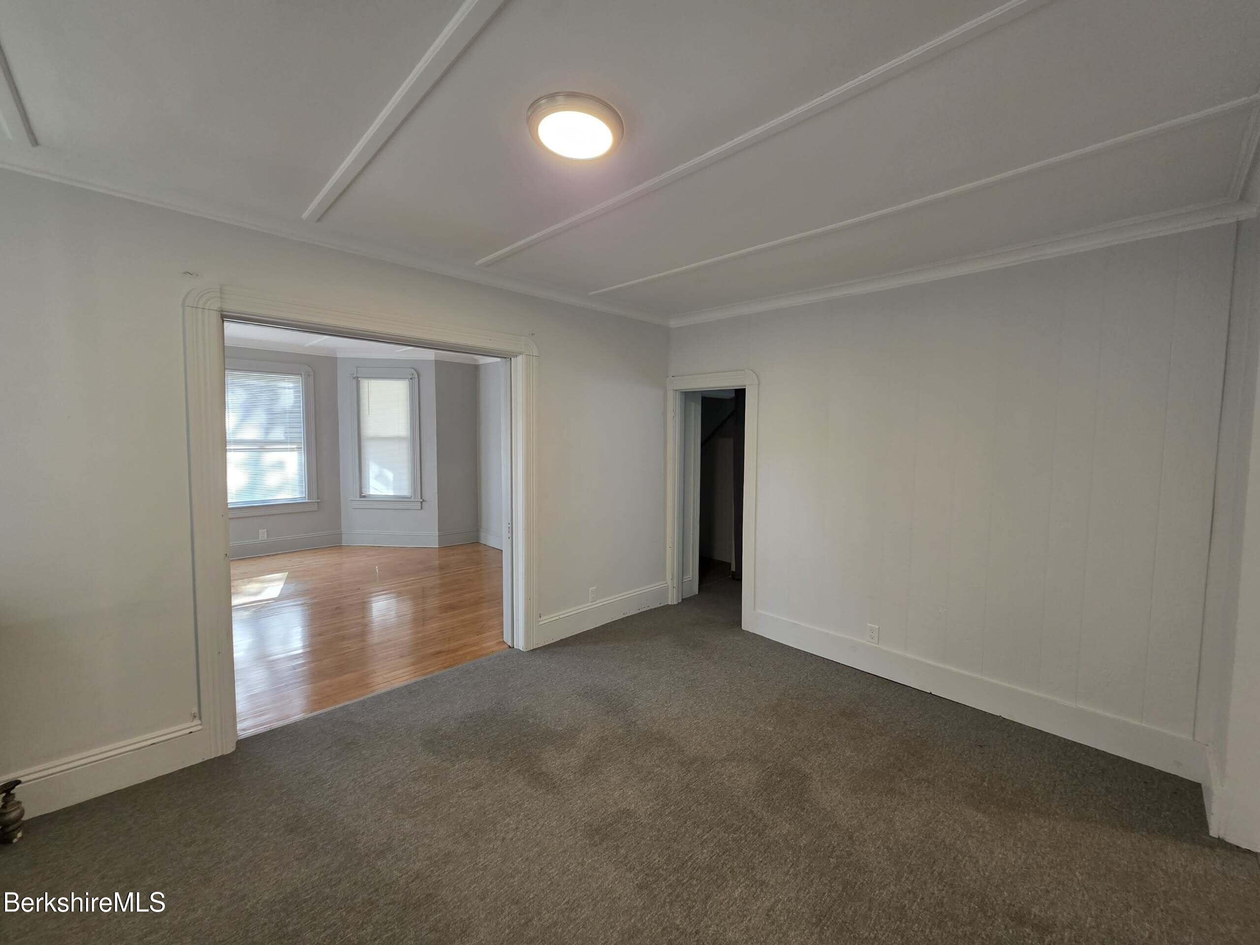 57 Beacon Street, Unit 1 North Adams, MA 01247 - Photo 5 of 10 an empty room with windows