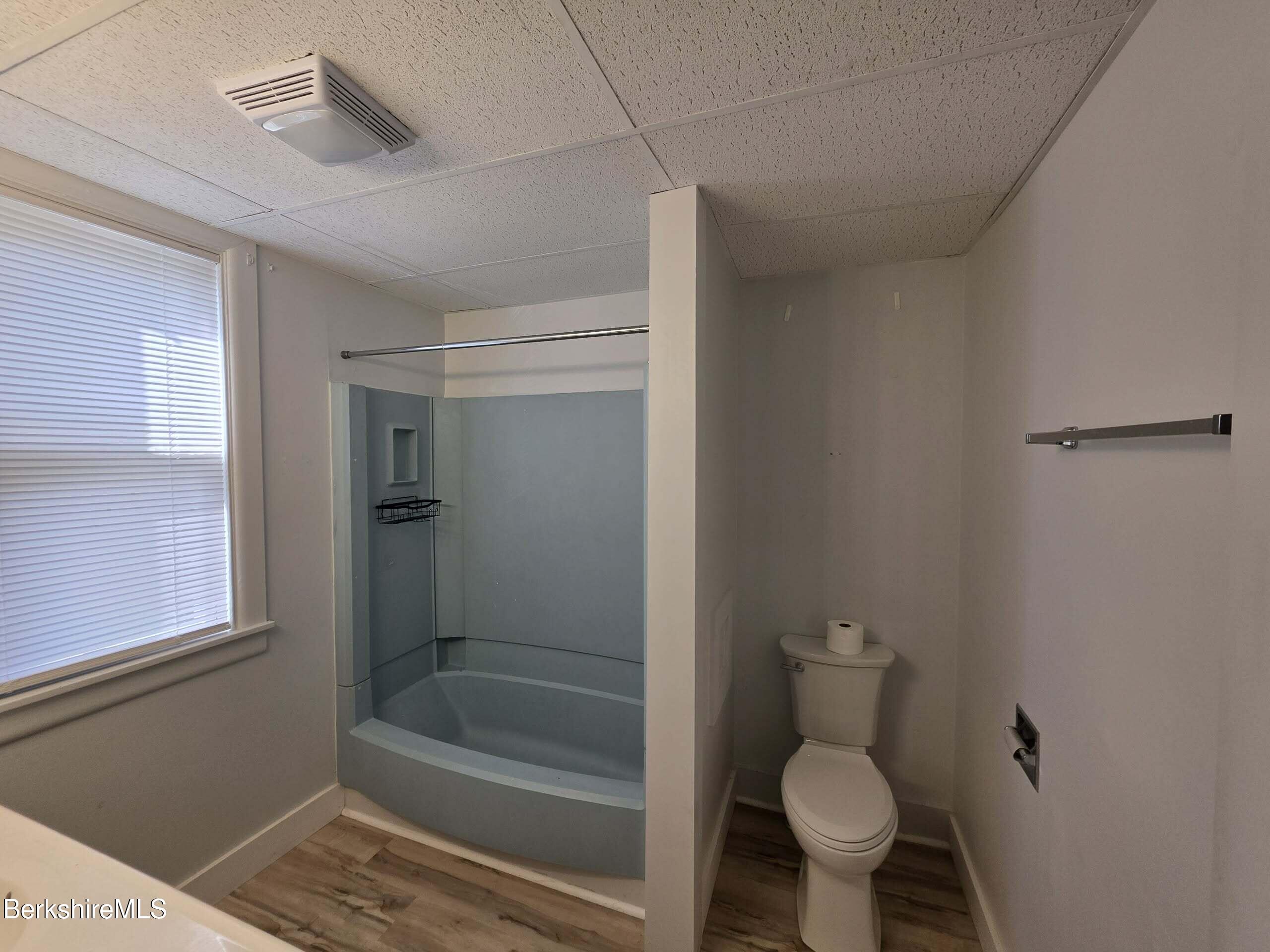 57 Beacon Street, Unit 1 North Adams, MA 01247 - Photo 9 of 10 a bathroom with a toilet and a shower