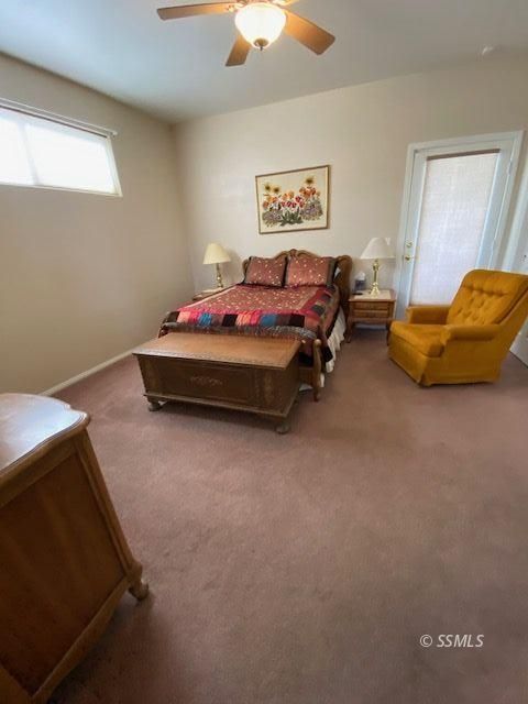 1145 West St George Avenue Ridgecrest, CA 93555 - Photo 12 of 16 a bedroom with bed and a chandelier