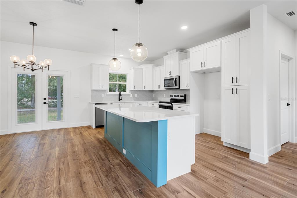 601 Fisher Drive Bronson, FL 32621 - Photo 5 of 32 a kitchen with kitchen island a sink stainless steel appliances and cabinets