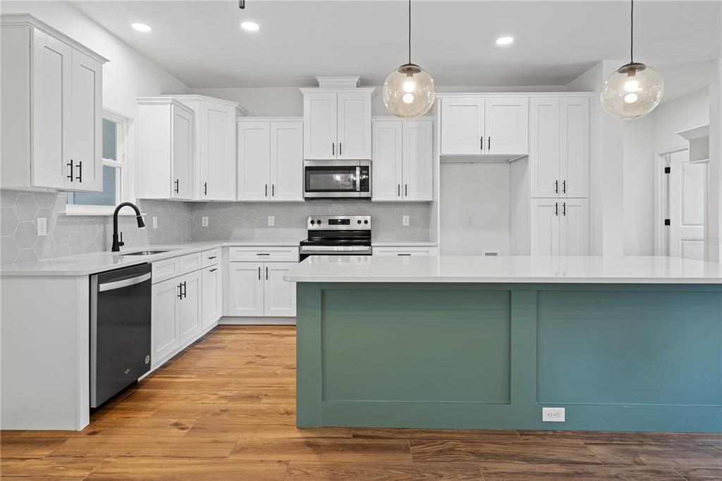 601 Fisher Drive Bronson, FL 32621 - Photo 7 of 32 a kitchen with stainless steel appliances granite countertop a sink a stove a refrigerator and cabinets