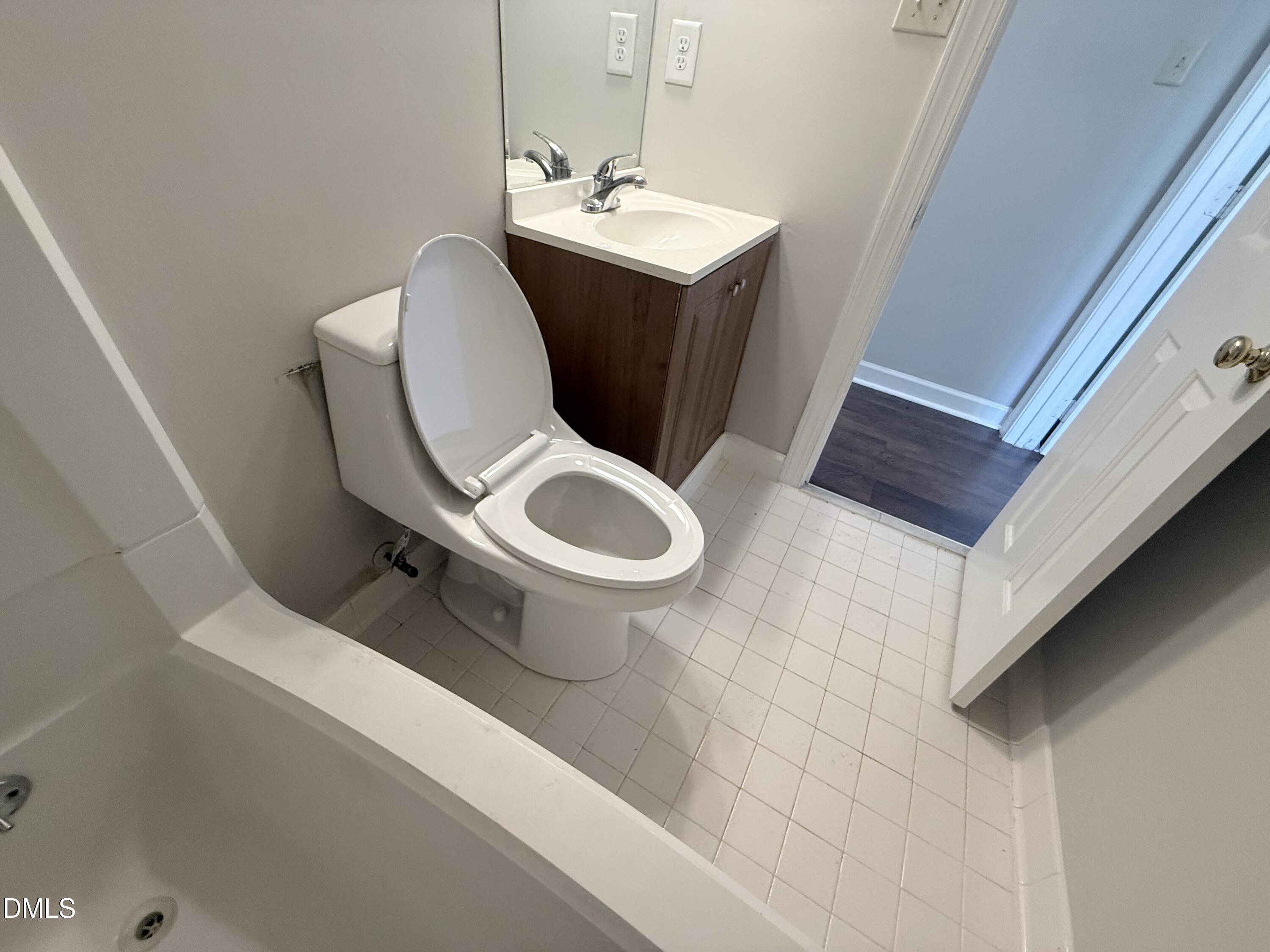 2900 Broadlands Drive Raleigh, NC 27604 - Photo 55 of 60 a white toilet sitting next to a bathroom sink