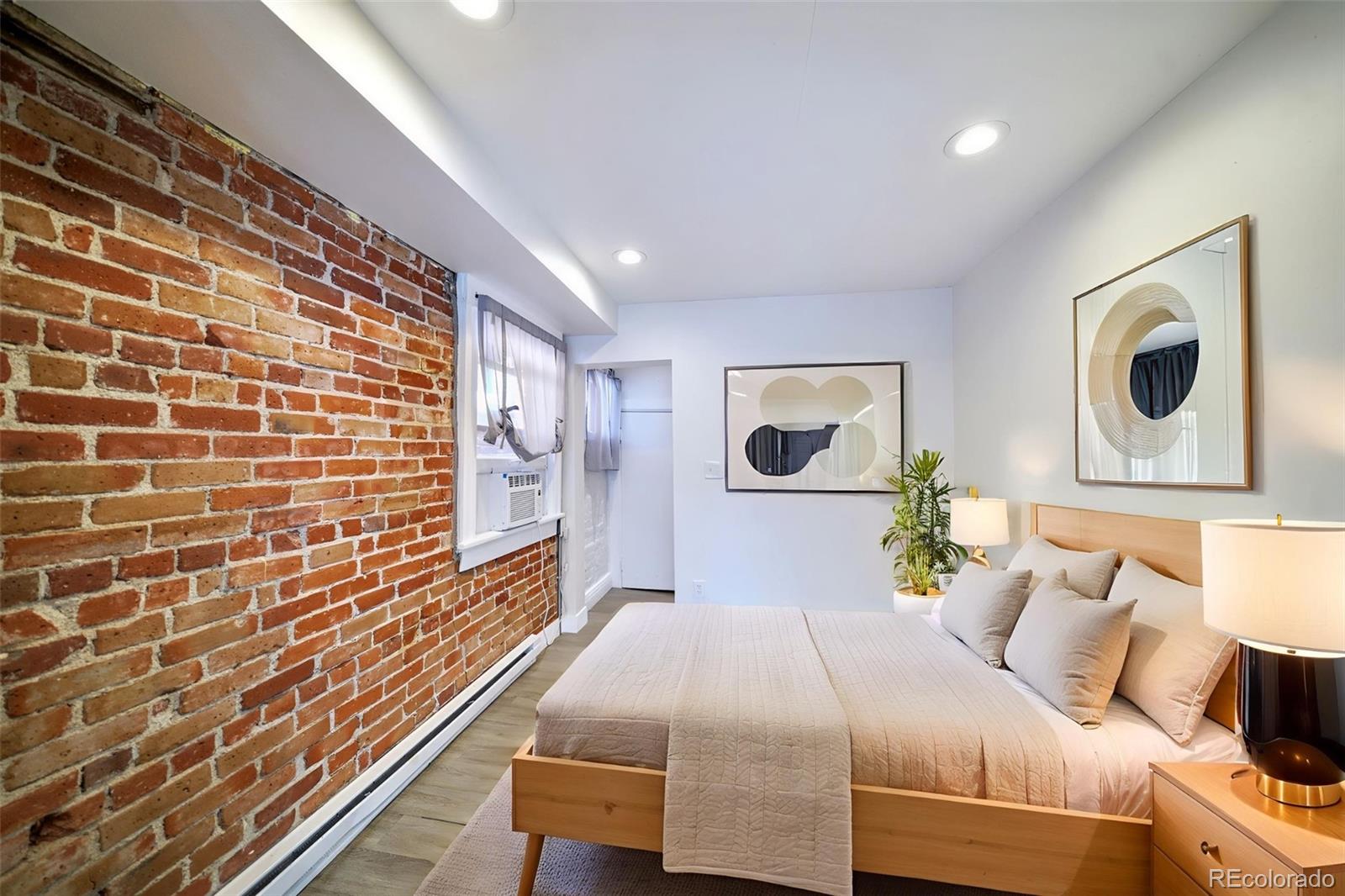 2528 West 23rd Avenue, Unit B Denver, CO 80211 - Photo 6 of 11 a bedroom with a bed and a mirror