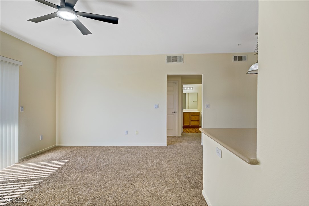 2291 West Horizon Ridge Parkway, Unit 11266 Henderson, NV 89052 - Photo 11 of 40 Spare room with light carpet and ceiling fan