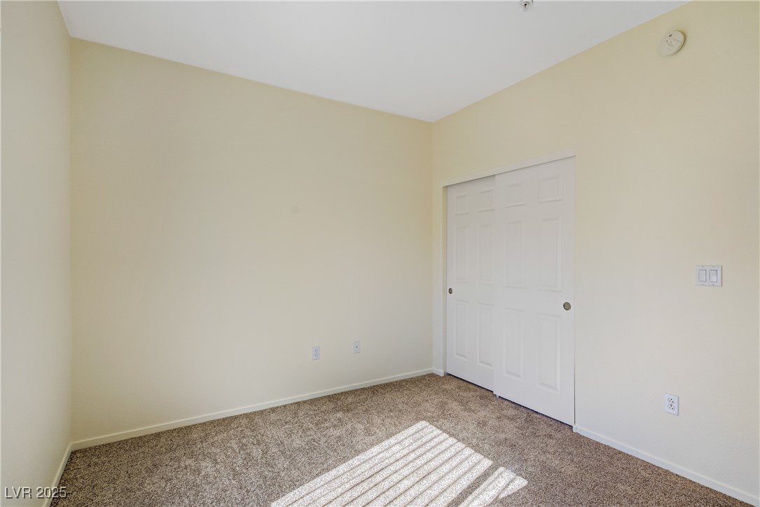 2291 West Horizon Ridge Parkway, Unit 11266 Henderson, NV 89052 - Photo 23 of 40 Unfurnished bedroom featuring carpet