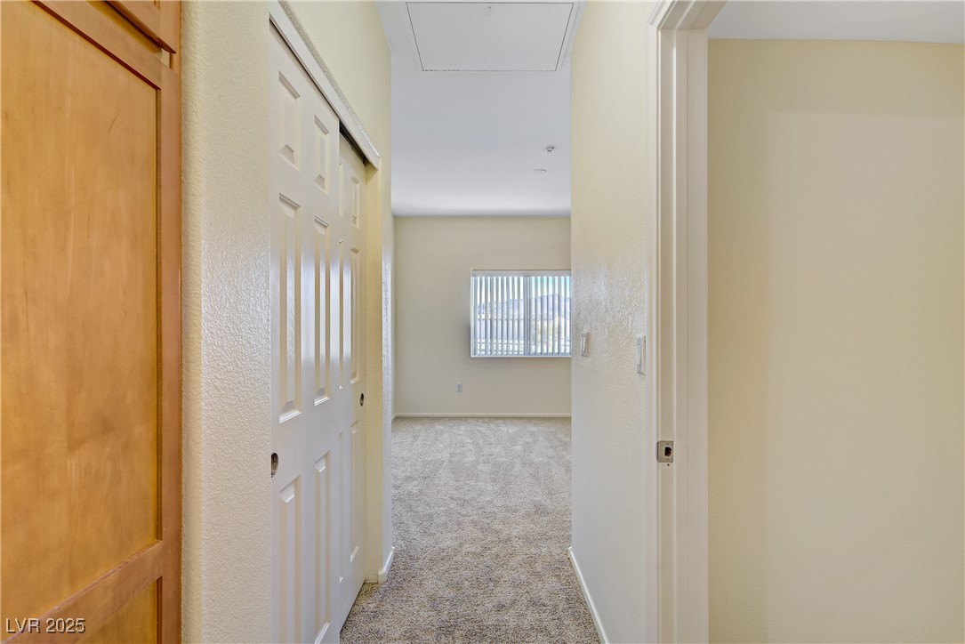 2291 West Horizon Ridge Parkway, Unit 11266 Henderson, NV 89052 - Photo 25 of 40 Hall with light carpet and baseboards