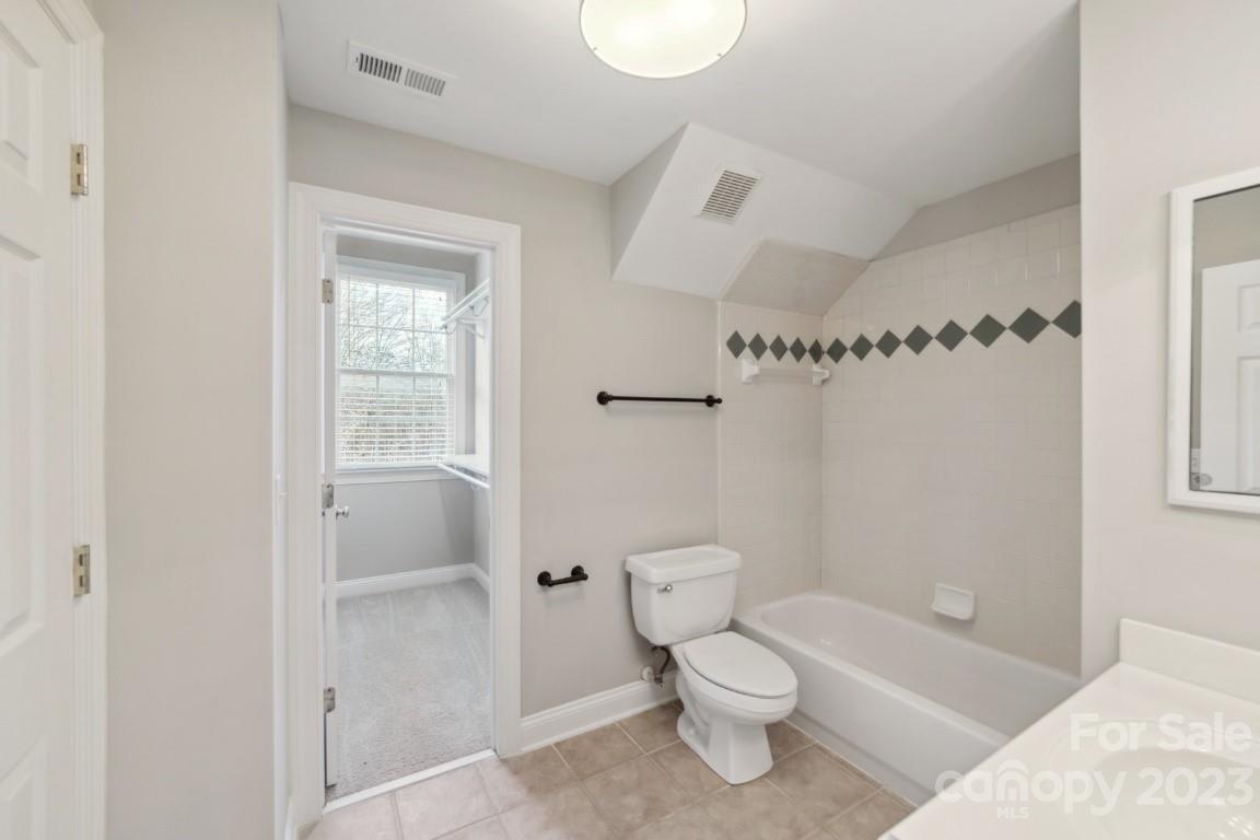 8403 Royster Run Waxhaw, NC 28173 - Photo 16 of 25 a white toilet sitting next to a bathroom sink and tub