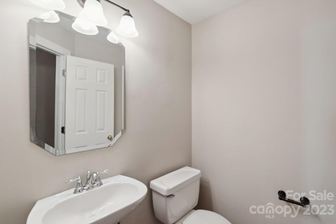 8403 Royster Run Waxhaw, NC 28173 - Photo 19 of 25 a bathroom with a toilet a sink and mirror