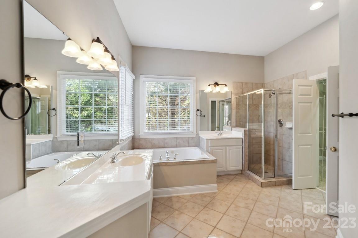 8403 Royster Run Waxhaw, NC 28173 - Photo 20 of 25 a large white bathroom with a large tub sink and window