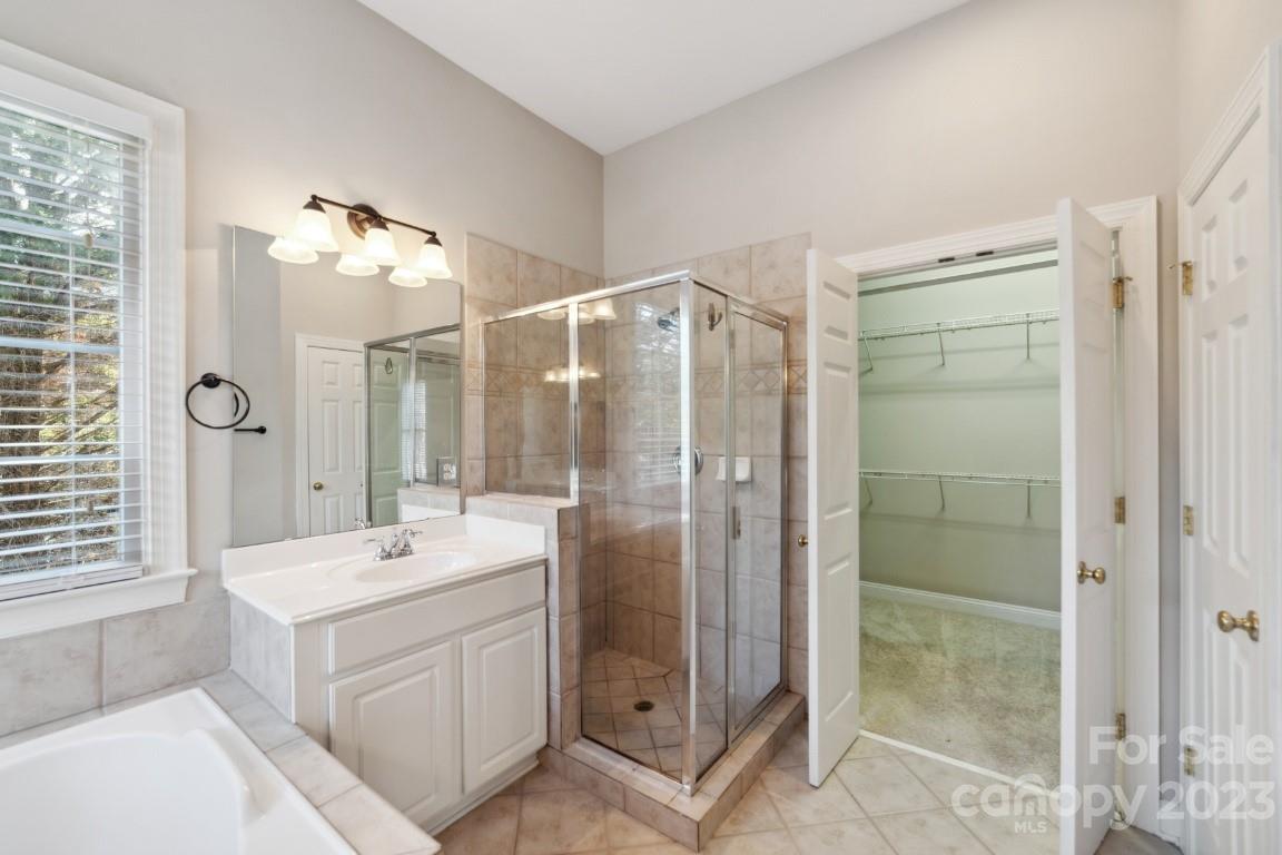 8403 Royster Run Waxhaw, NC 28173 - Photo 21 of 25 a bathroom with a double vanity sink mirror and shower