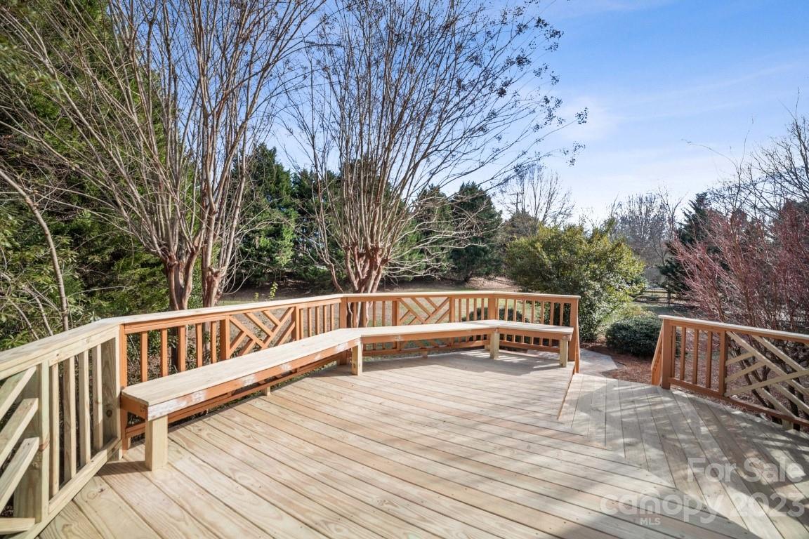 8403 Royster Run Waxhaw, NC 28173 - Photo 22 of 25 a view of balcony with wooden floor and trees