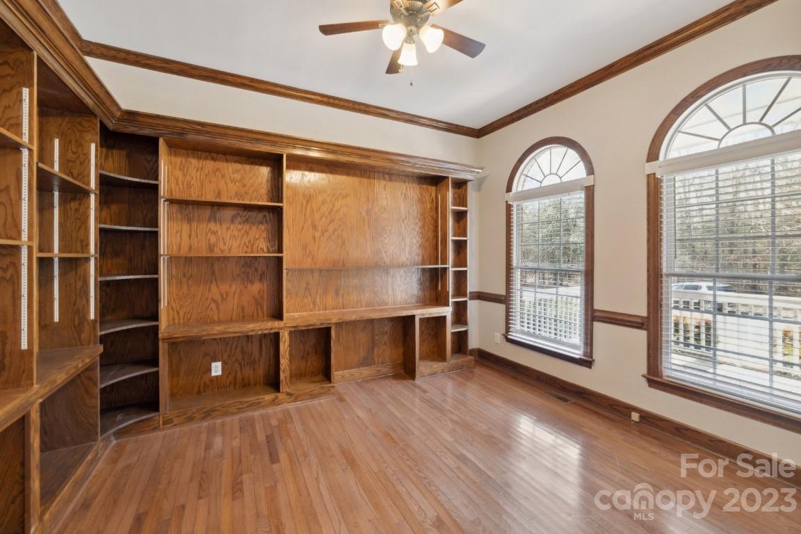 8403 Royster Run Waxhaw, NC 28173 - Photo 4 of 25 a view of an empty room with a window and wooden floor