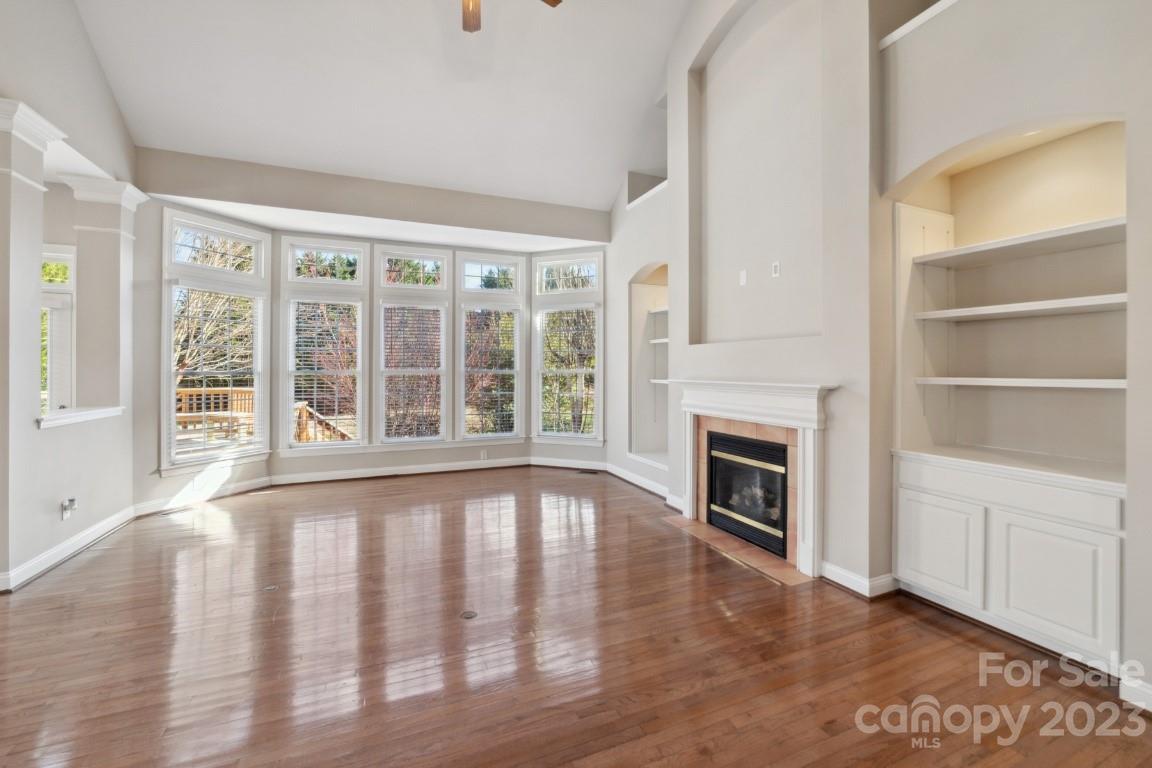 8403 Royster Run Waxhaw, NC 28173 - Photo 5 of 25 a view of an empty room with a fireplace and a window