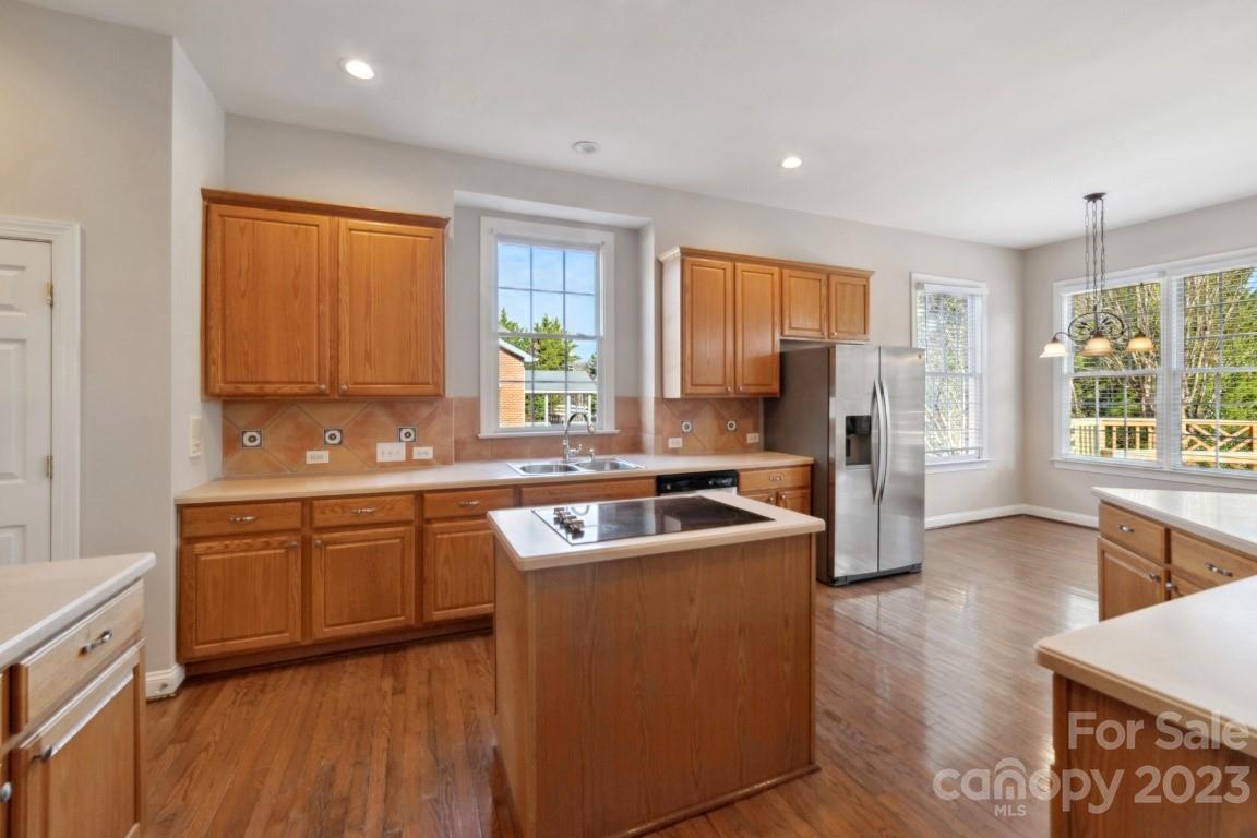 8403 Royster Run Waxhaw, NC 28173 - Photo 7 of 25 a kitchen with stainless steel appliances granite countertop wooden floors and sink