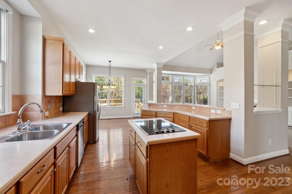 8403 Royster Run Waxhaw, NC 28173 - Photo 8 of 25 a kitchen with stainless steel appliances granite countertop a sink stove and refrigerator