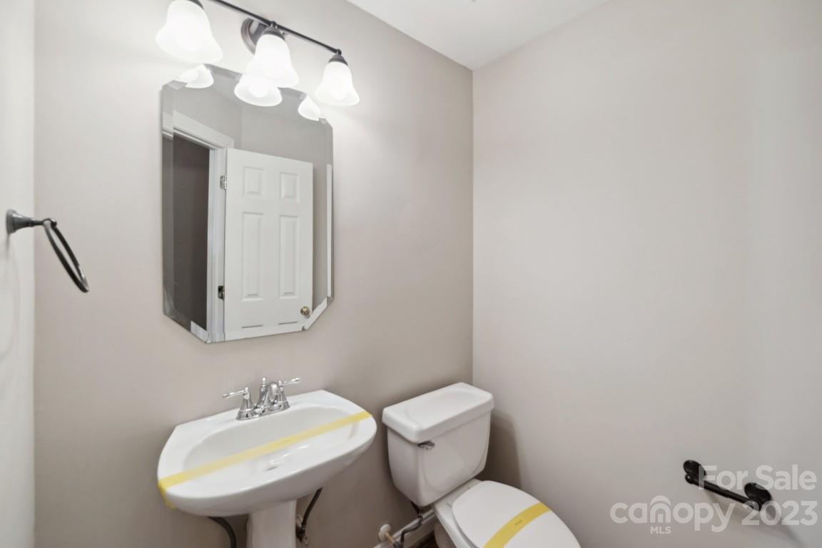 8403 Royster Run Waxhaw, NC 28173 - Photo 10 of 25 a bathroom with a toilet sink and mirror