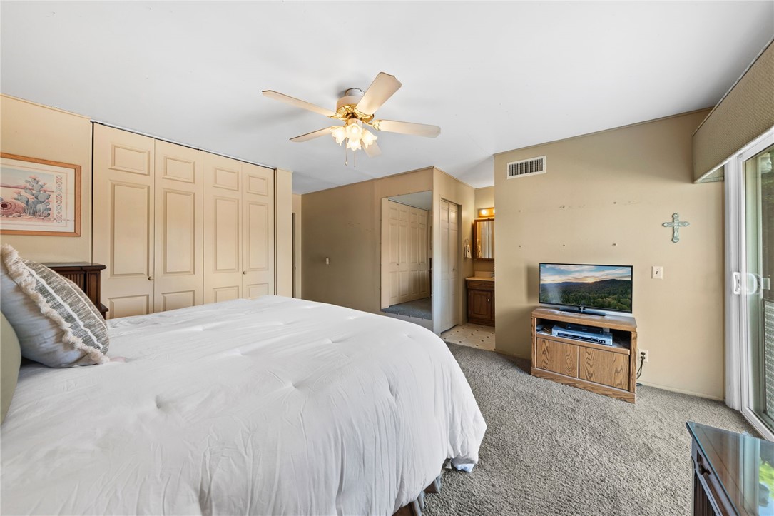 1981 Chevy Chase Drive Brea, CA 92821 - Photo 20 of 52 a spacious bedroom with a bed and a chandelier
