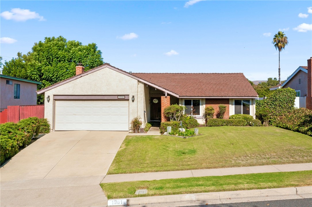 1981 Chevy Chase Drive Brea, CA 92821 - Photo 42 of 52 a front view of a house with a yard