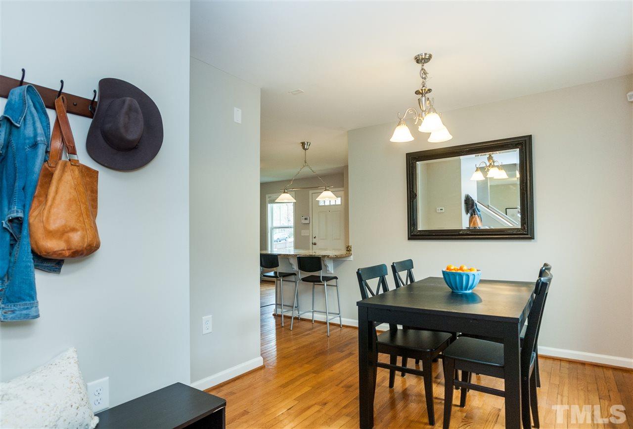 904 Dorothy Sanders Way Raleigh, NC 27601 - Photo 14 of 25 a view of a dining room with furniture and chandelier