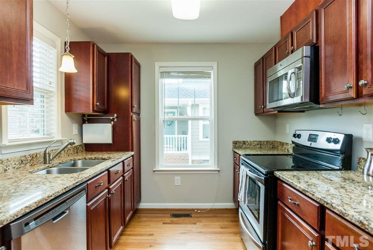 904 Dorothy Sanders Way Raleigh, NC 27601 - Photo 8 of 25 a kitchen with stainless steel appliances granite countertop a stove and a sink