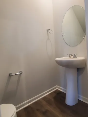 a bathroom with a sink toilet and mirror