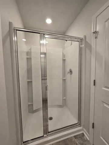 a bathroom with a glass shower door