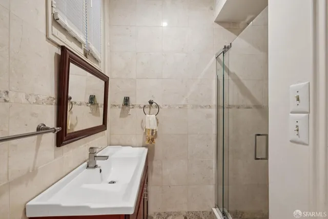 a bathroom with a sink and mirror with toilet