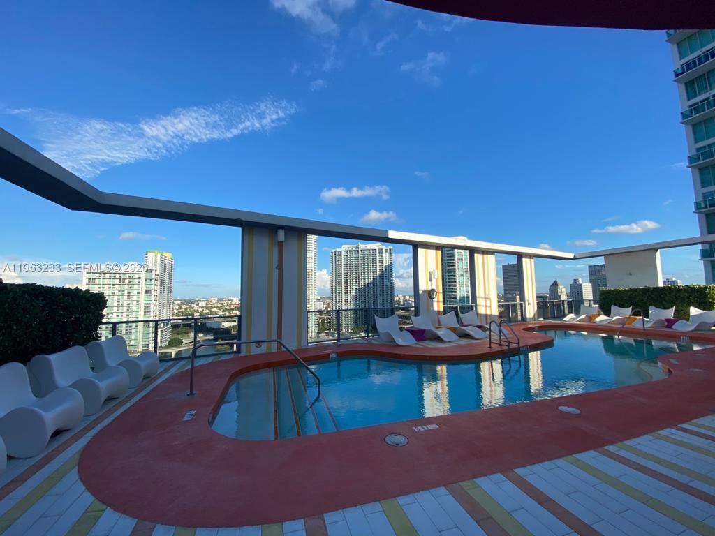 31 Southeast 6th Street, Unit 1404 Miami, FL 33131 - Photo 13 of 13 a view of a living room and kitchen with furniture