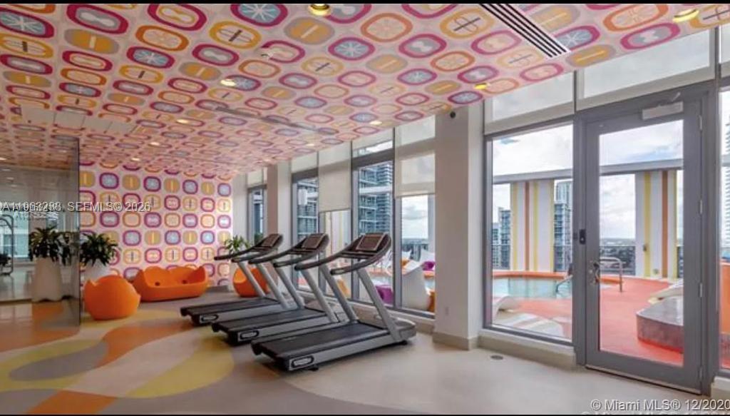31 Southeast 6th Street, Unit 1404 Miami, FL 33131 - Photo 5 of 13 a view of a room with gym equipment