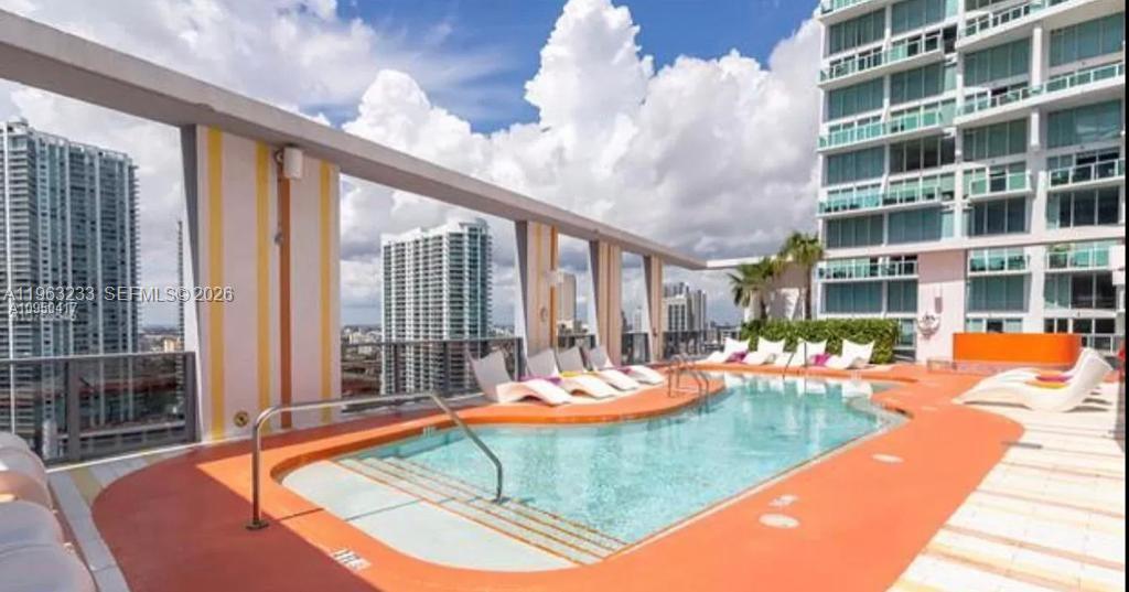 31 Southeast 6th Street, Unit 1404 Miami, FL 33131 - Photo 6 of 13 a view of a living room and kitchen