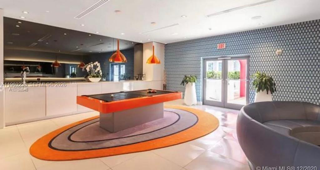 31 Southeast 6th Street, Unit 1404 Miami, FL 33131 - Photo 7 of 13 a living room with furniture and a fireplace