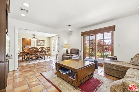 a living room with furniture and next to a window