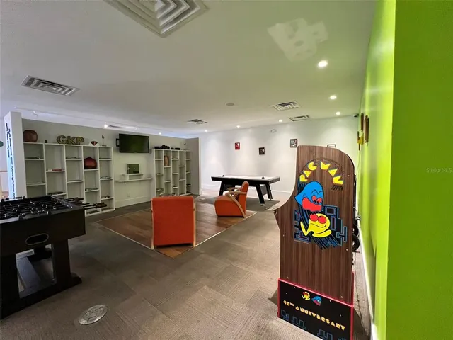 a living room with furniture pool table and a window