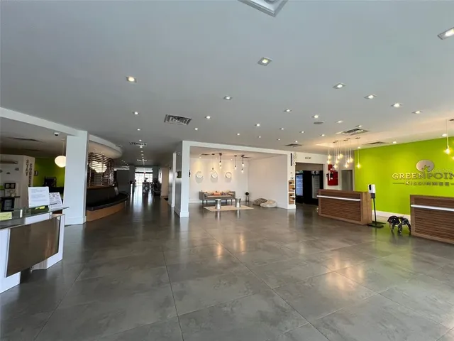 a view of a kitchen with dining table and chairs in it