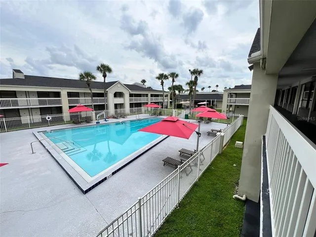 a view of a pool with an outdoor seating