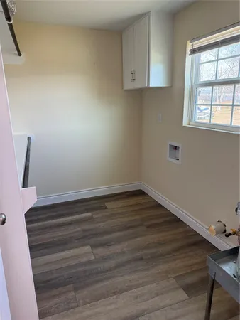 a room with wooden floor and windows
