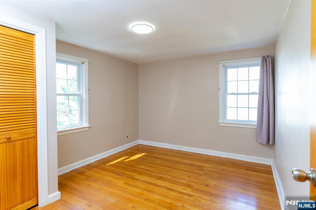 397 Hickory Avenue Paramus, NJ 07652 - Photo 11 of 14 a view of empty room with wooden floor and fan