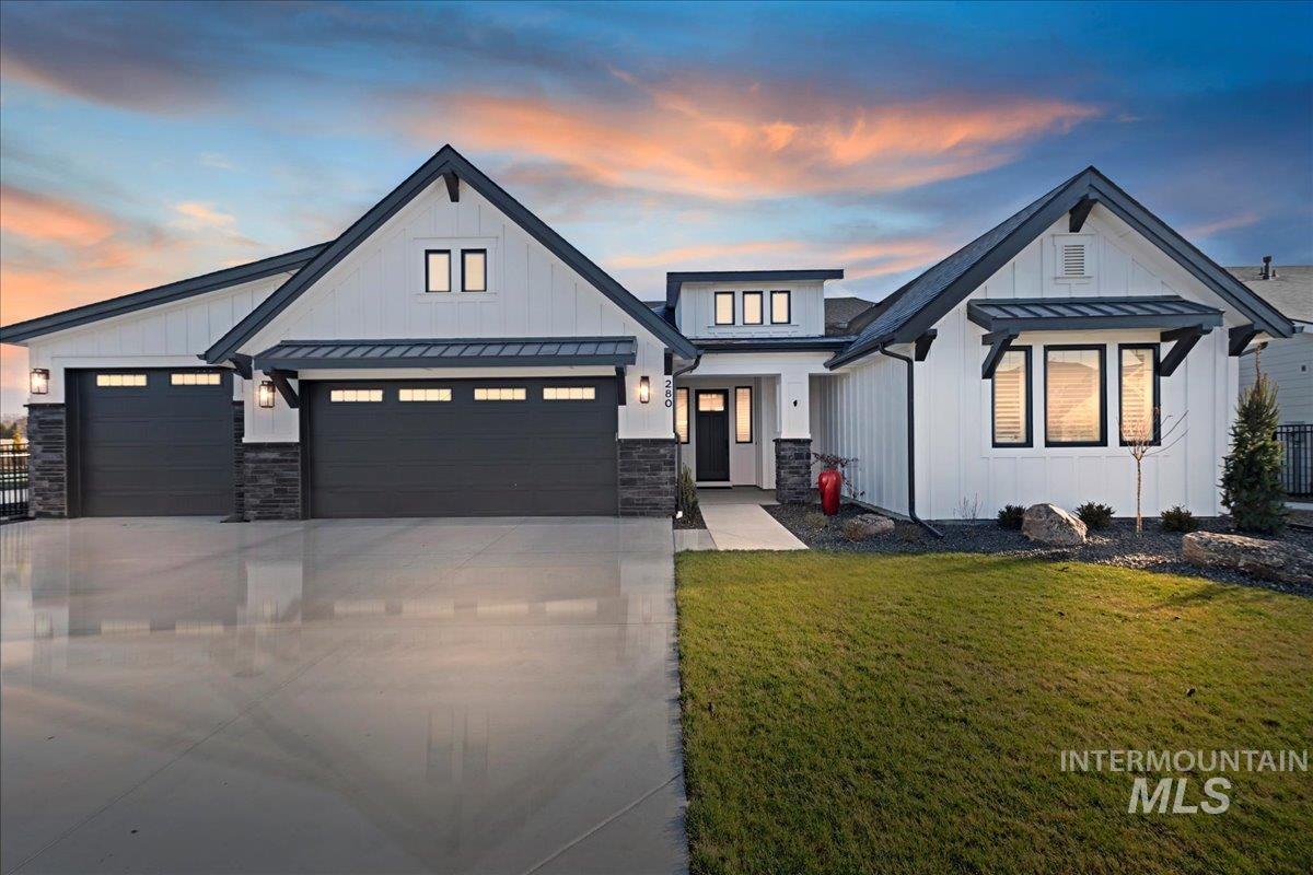 280 North Boulder Rdg Way Eagle, ID 83616 - Photo 1 of 50 View of front of home featuring a standing seam roof, a metal roof, driveway, a lawn, and board and batten siding